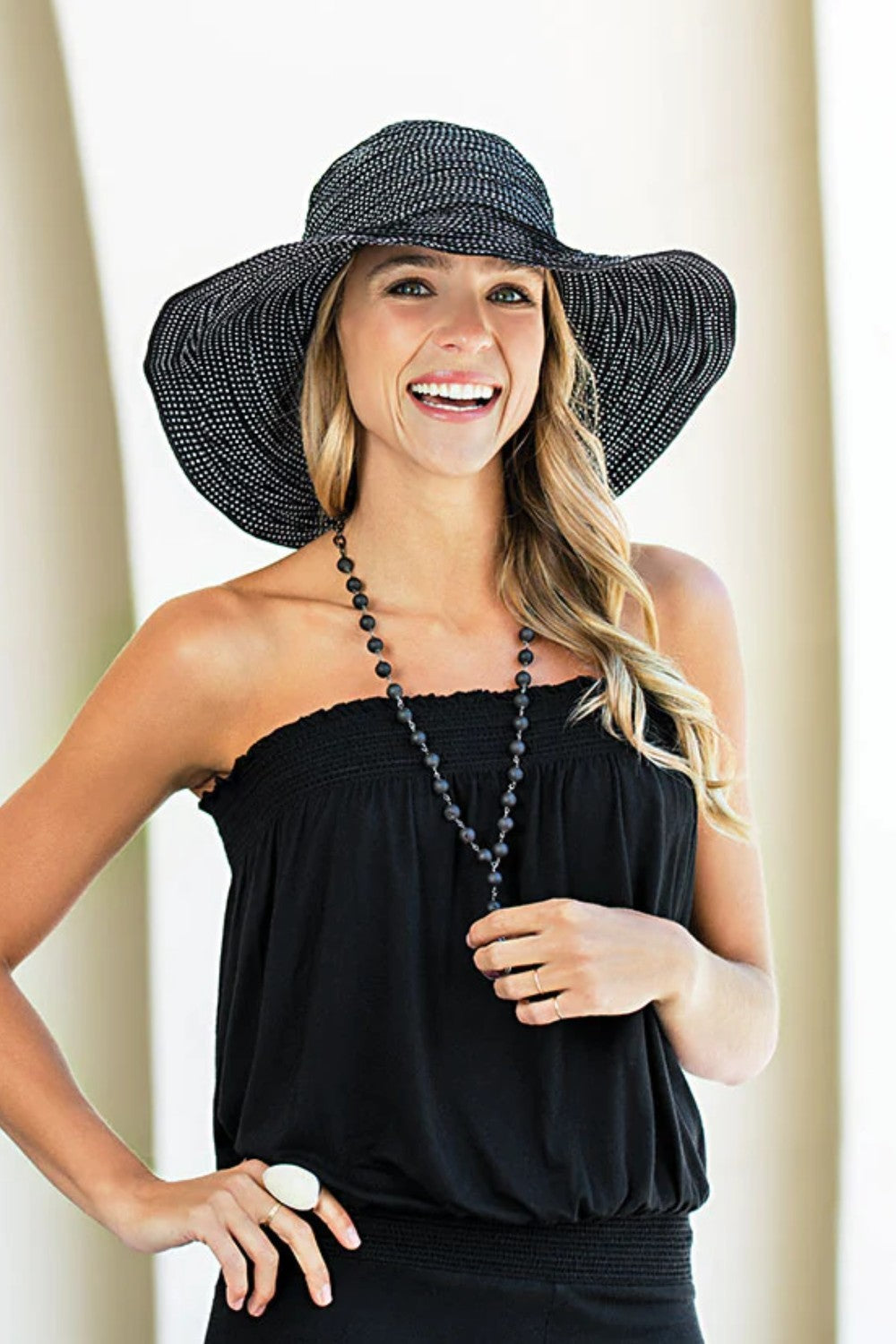 Charming white polka dots cover the classic black Scrunchie hat for a timeless look. The wire-edged brim hat can be adjusted for every mood – straighten it out for a stylish silhouette or wear it wavy for a flirty look. The wide brim allows for maximum sun protection.