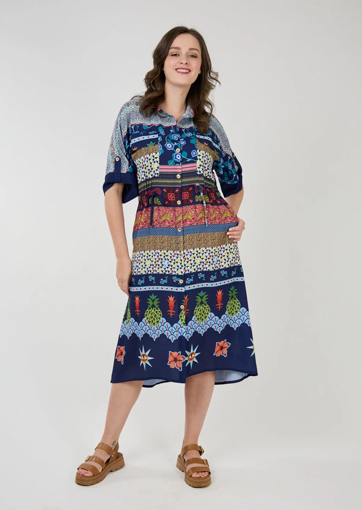 Striking button front dress in a colourful and vibrant print, by Shannon Passero.  This dress features roll tab short sleeves, 2  oversized chest pockets , a tie at the waist and side pockets!