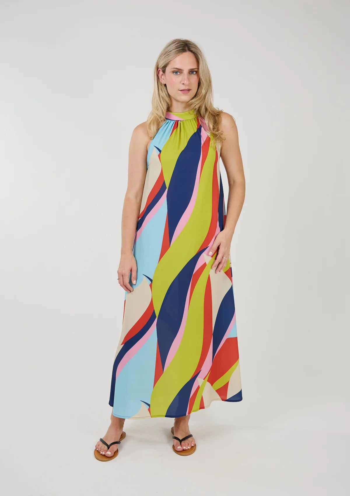 Striking sleeveless maxi dress in a bold & vibrant wave print, by Shannon Passero.  This dress features a button closure up the entire back and pockets!