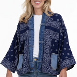 Woman wearing a blue patterned jacket on a white background