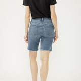 Person wearing a black t-shirt and blue denim shorts on a white background