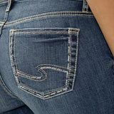 Close-up of blue jeans with a brand logo on the pocket.