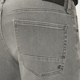 Gray jeans with a brand label on the back pocket against a neutral background