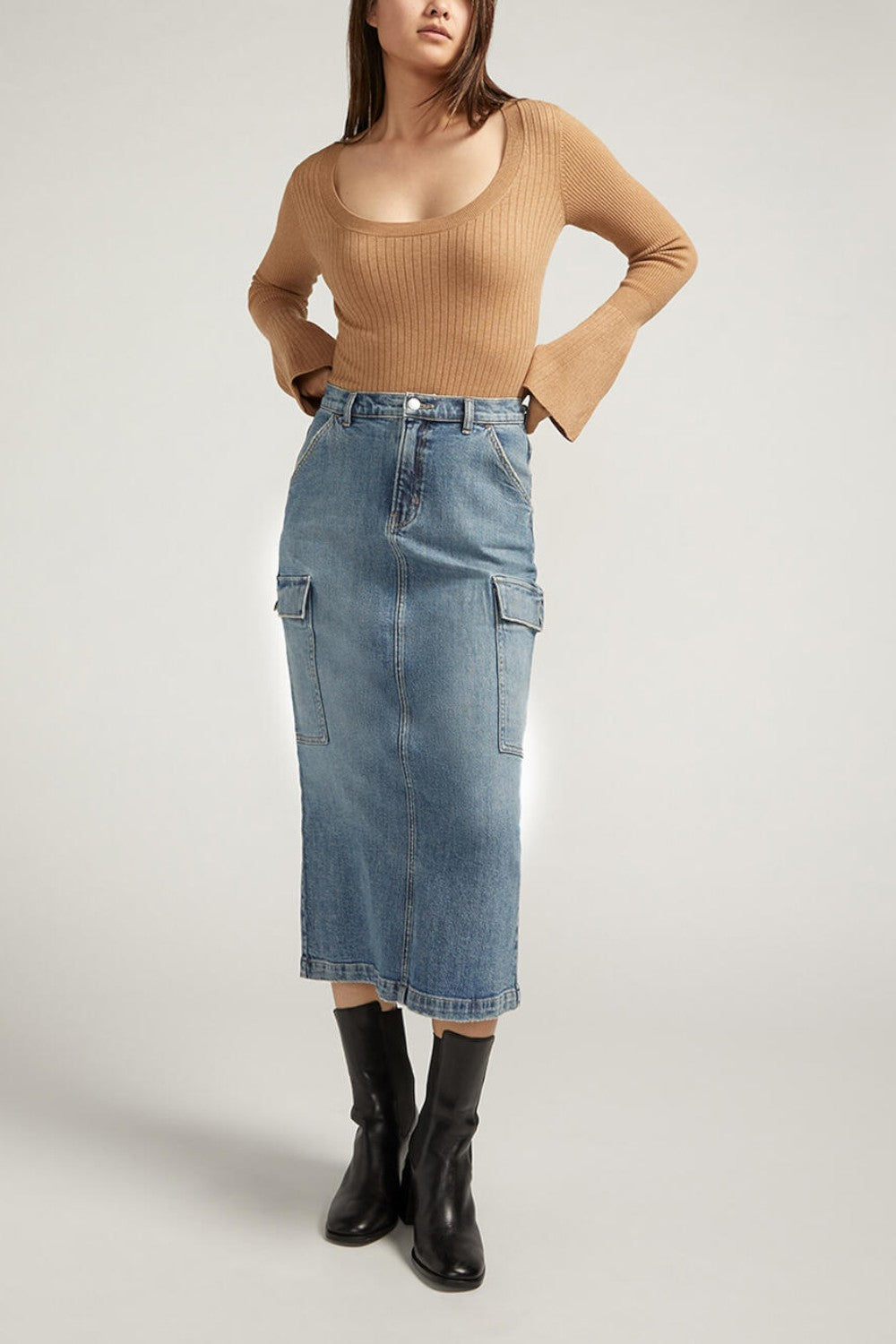 Meet your staple denim skirt for spring and beyond. Our medium wash midi cargo skirt is the perfect statement piece, dressed up or down. With side cargo pockets and a back slit, this is a skirt you'll love wearing everywhere.