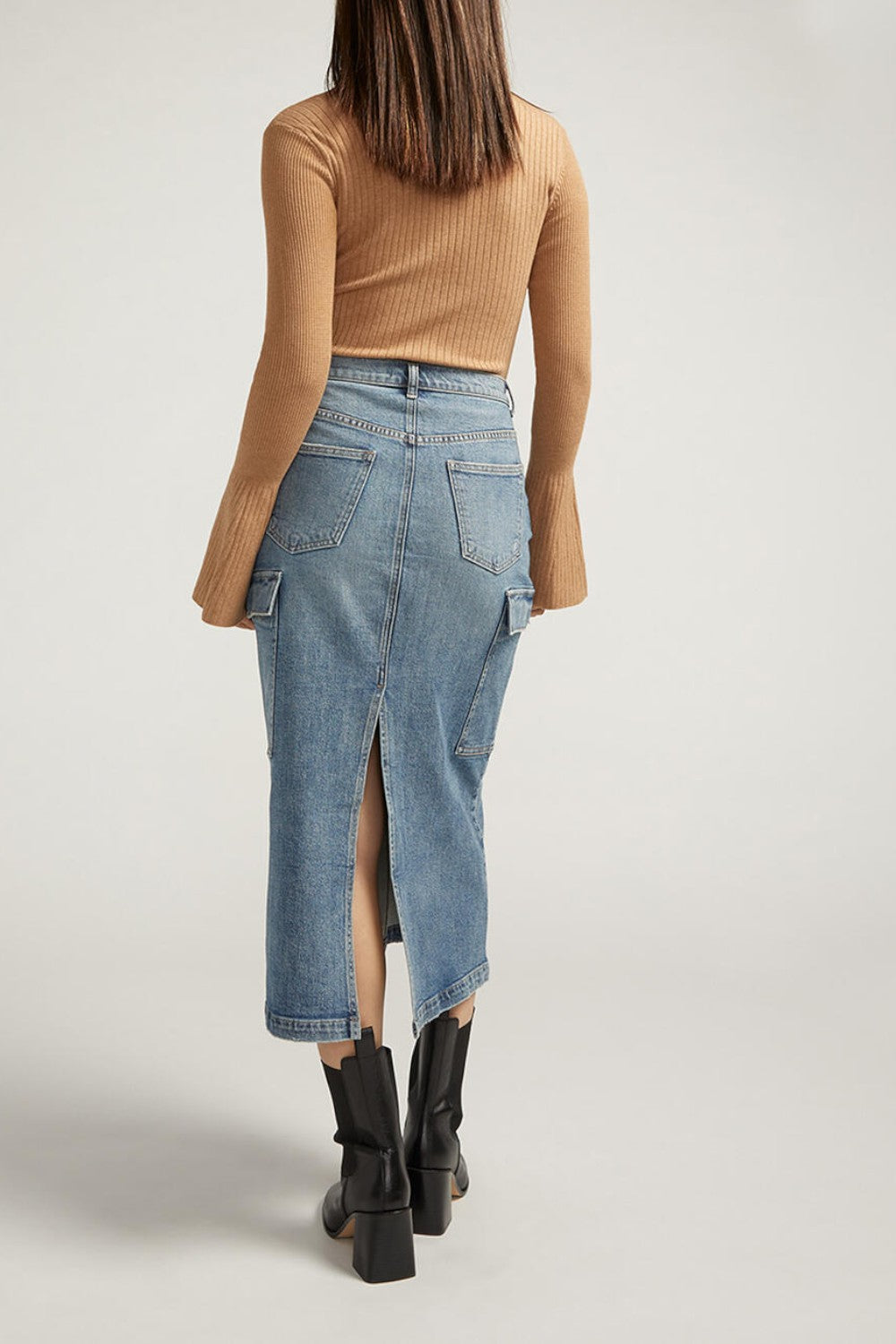 Meet your staple denim skirt for spring and beyond. Our medium wash midi cargo skirt is the perfect statement piece, dressed up or down. With side cargo pockets and a back slit, this is a skirt you'll love wearing everywhere.