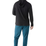 Man wearing a black hoodie and blue pants on a white background