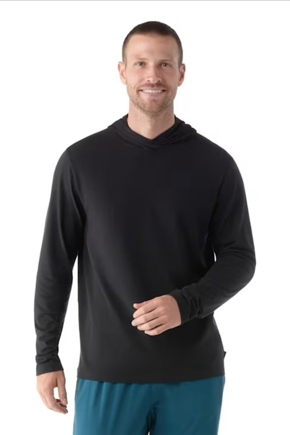 Man wearing a black hoodie and blue pants on a white background