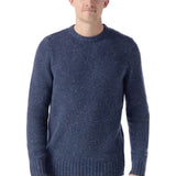 Man wearing a blue knitted sweater on a white background