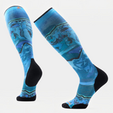A pair of knee-high athletic socks with a blue and teal abstract pattern and black heels, toes, and cuffs, displayed on a light gray background.