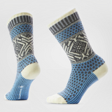 A pair of crew socks with a blue, gray, and cream Nordic pattern, shown on a light gray background.