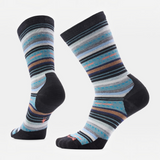 A pair of crew socks with a striped pattern in shades of blue, gray, black, and brown, featuring solid black heels, toes, and cuffs. A small logo is visible on the sole of the right sock.