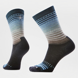 Crew length socks with a mostly black foot and tan, grey and blue stripes on a light background.