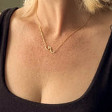 Ride the wave with this Chainlink Necklace featuring a handmade wave pendant. Gold plated for a delicate touch, this necklace is perfect for any occasion.