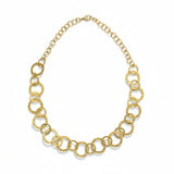 Gold necklace with circles looped together on white background