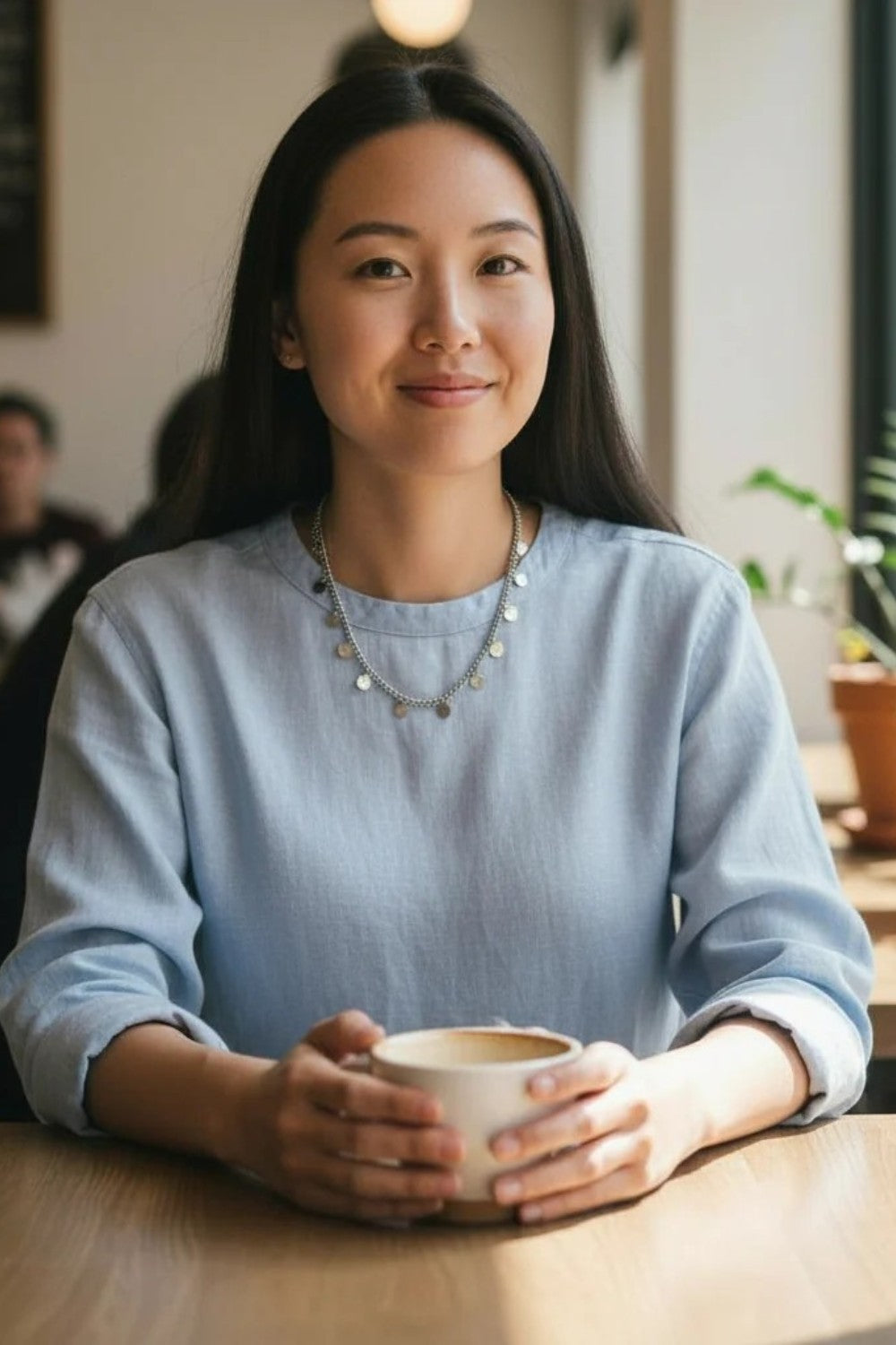 Woman holding a cup in a casual indoor setting