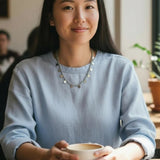Woman holding a cup in a casual indoor setting