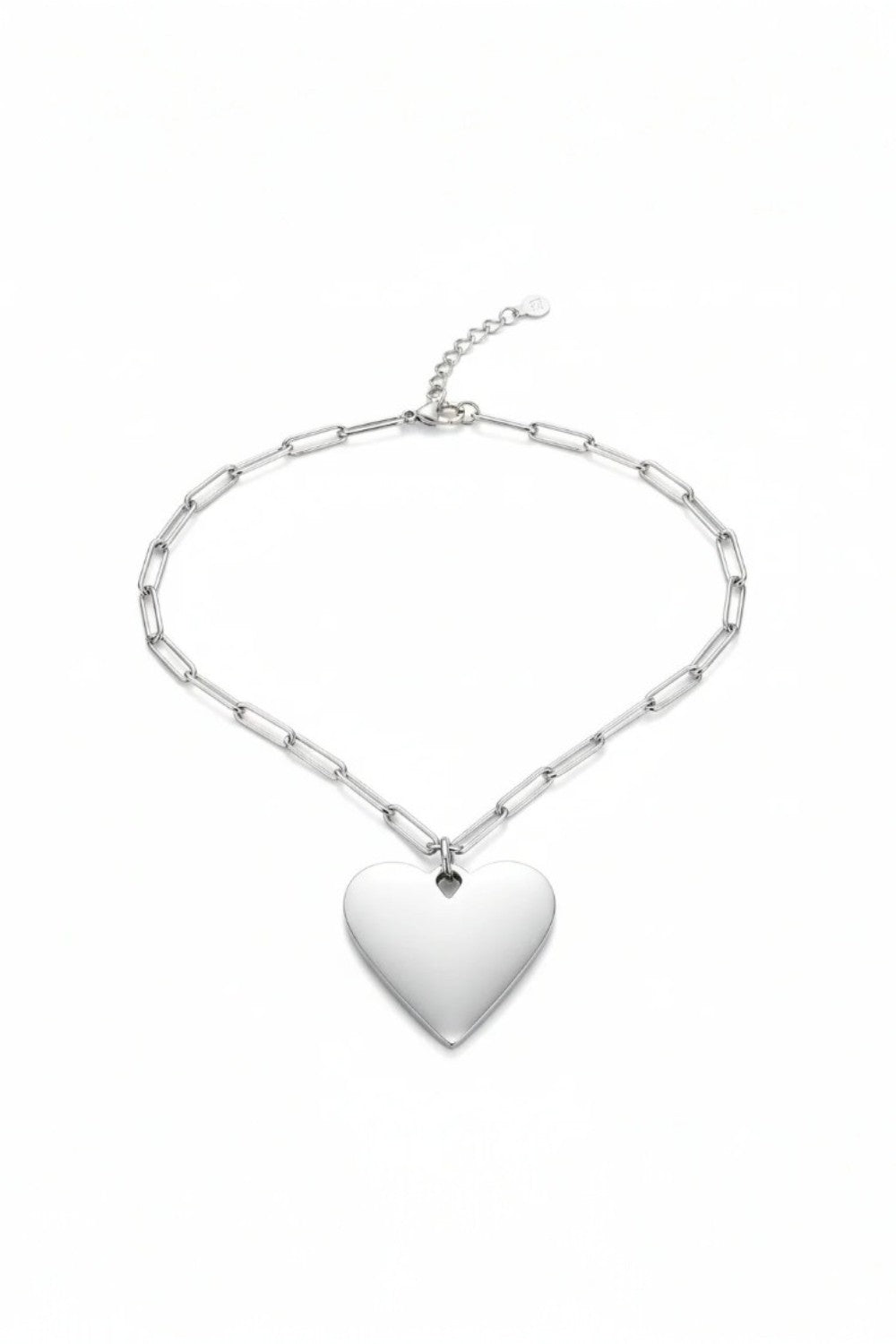 Silver chain necklace with a heart-shaped pendant on a white background