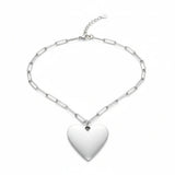 Silver chain necklace with a heart-shaped pendant on a white background