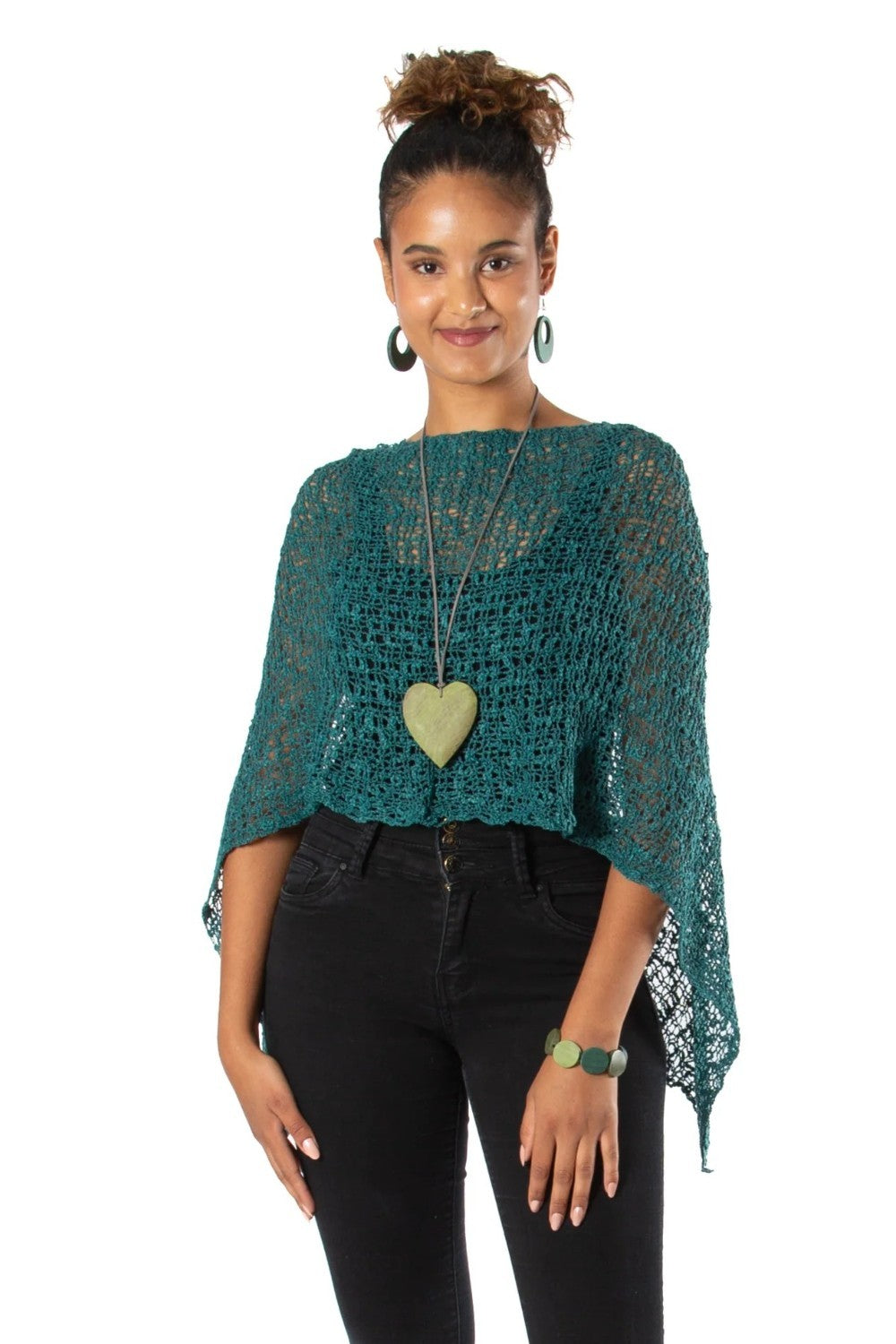 Woman wearing a green crochet top with a white background