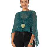 Woman wearing a green crochet top with a white background