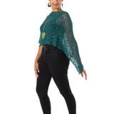 Woman wearing a green crochet top and black pants on a white background