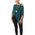 Woman wearing a green poncho and black leggings on a white background