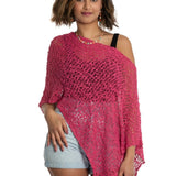 Woman wearing a pink crochet cover-up on a white background