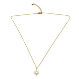 Gold necklace with a single pearl pendant on a white background