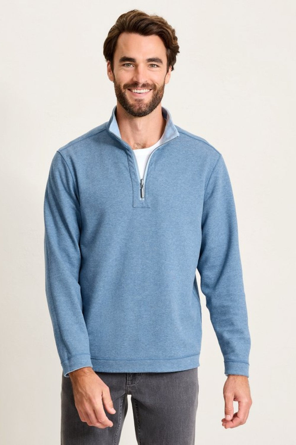 Man wearing a blue pullover with a white background