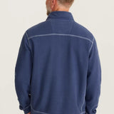 Man wearing a blue fleece jacket on a light background