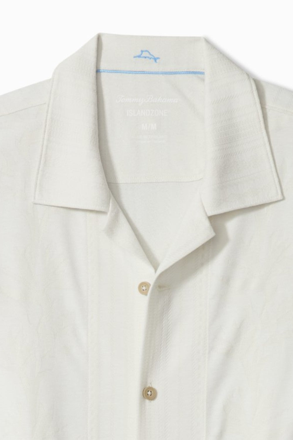 Close-up of a white polo shirt with a collar and buttons on a white background
