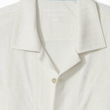 Close-up of a white polo shirt with a collar and buttons on a white background