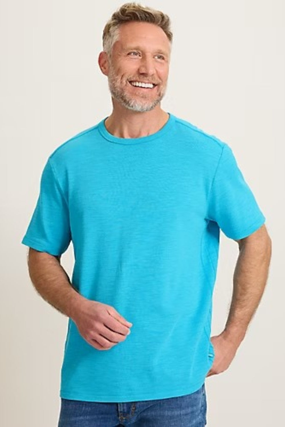Man wearing a bright blue t-shirt against a plain background