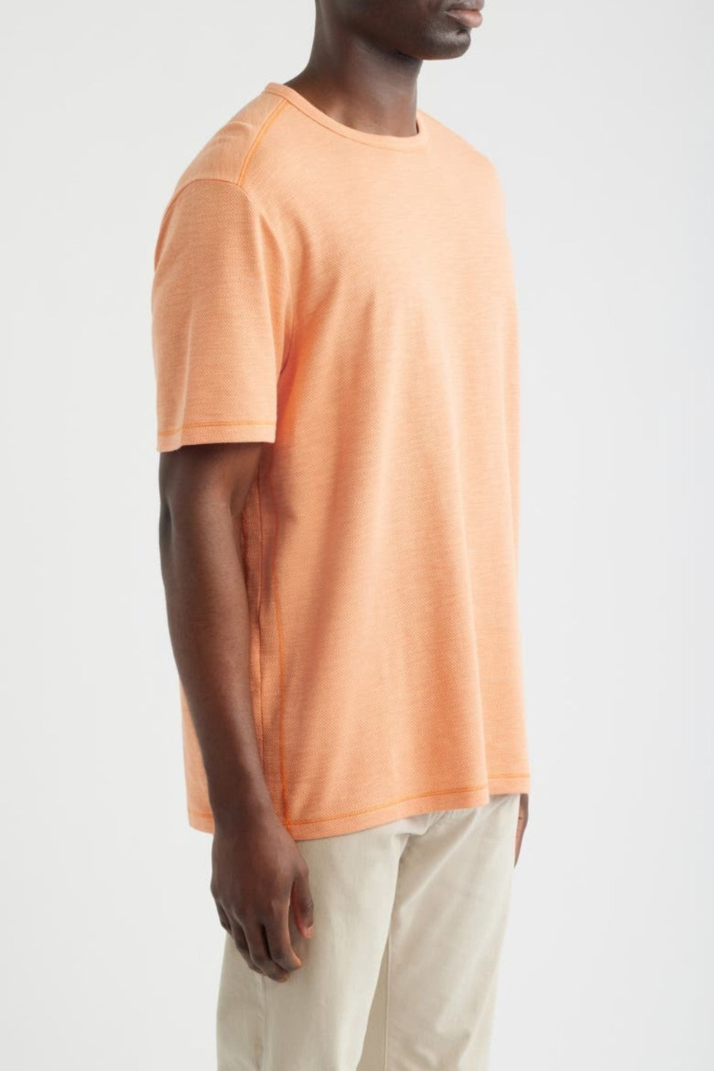 Person wearing an orange t-shirt on a white background