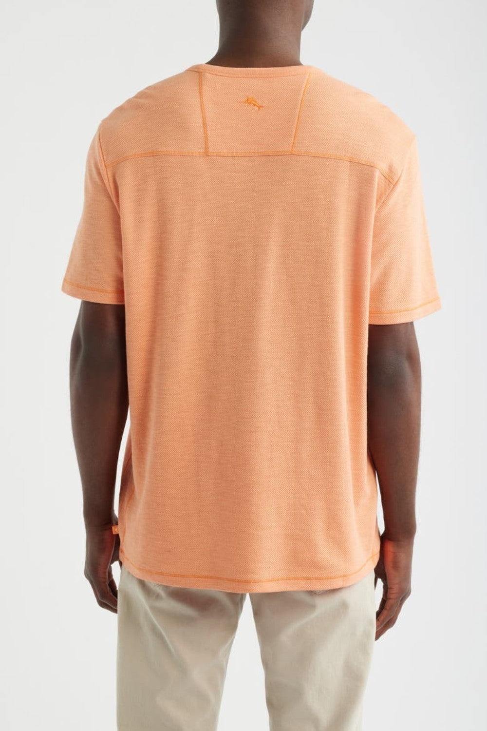 Person wearing an orange t-shirt on a white background