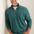 Man wearing a teal pullover with a zipper, standing against a plain background