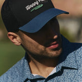 The SWING SEASON HAT leans into that stretch of the year everyone waits for, pairing a breezy two-tone mesh snapback with golf-inspired art and a subtle grass embroidery detail that rewards a closer look. Light, easy, and unmistakably on trend, it’s the hat that says the good rounds are just getting started.