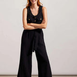 Nail that one-and-done look and instantly revive your warm-weather style by slipping into this sleeveless jumpsuit flaunting little bits of flair and a comfortable fit. We're crushing on the button-front bodice framed by patch pockets, dainty spaghetti straps, 25" inseam, and crinkled gauze fabric that offers lightweight coverage.