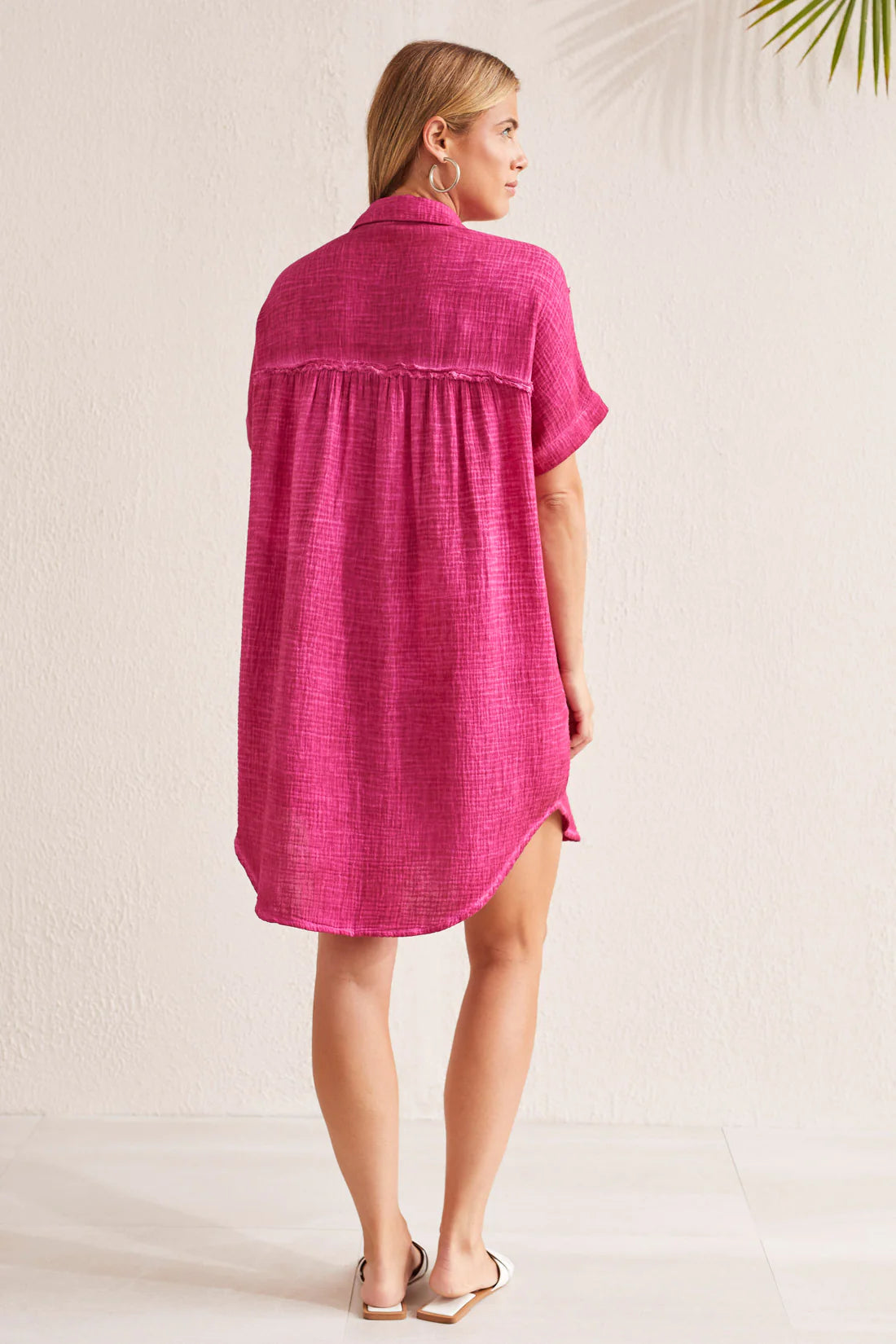Elevate your sunny day style with this shirt dress made from crinkled gauze fabric that's lightweight and flowy. It stays breezy with a loose fit, short dolman sleeves, a button-up front, and curved high-low hem.
