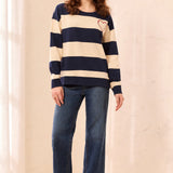 This charming long-sleeve knit pullover features a classic nautical stripe pattern accented by a vibrant embroidered red heart for a playful, romantic touch. Designed with a relaxed drop shoulder and a cozy crew neckline, it offers an effortless silhouette that perfectly balances casual comfort with elevated style.