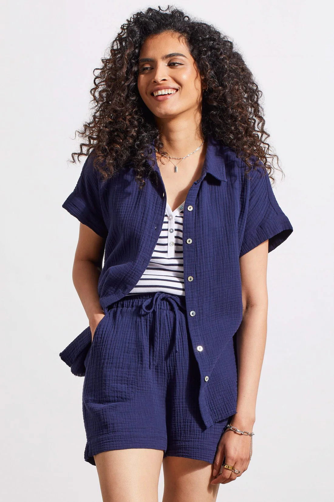 Rocking a classic button-up front, collared neckline, and short sleeves, this shirt brings refined style to warm days. We love the airy dolman design, rolled cuffs, raw-edge hem, and crinkled gauze cotton that stays lightweight from morning until night.