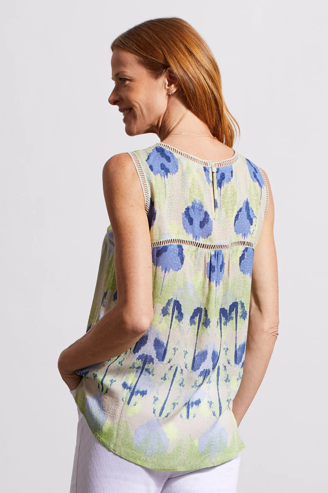 A colourful print cut from breezy fabric gives this sleeveless blouse a flowy fit. A side slit hem and ladder tape details add a chic touch.