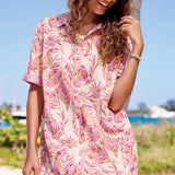 Woman wearing a pink dress and straw hat with a scenic background