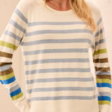 Woman wearing a striped sweater with a plain background