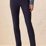 Navy blue pants worn by a person on a beige background