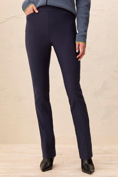 Navy blue pants worn by a person on a beige background