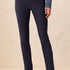 Navy blue pants worn by a person on a beige background