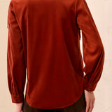Person wearing an orange jacket with a blurred background