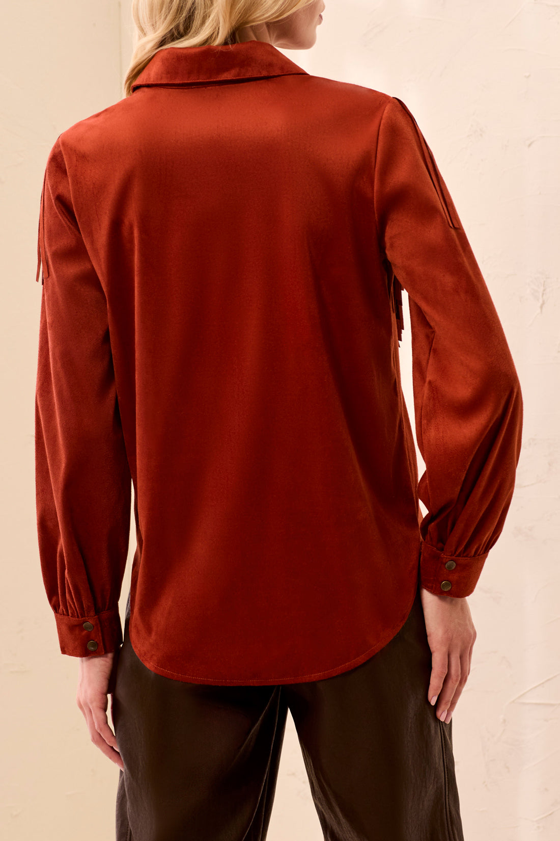 Person wearing an orange jacket with a blurred background