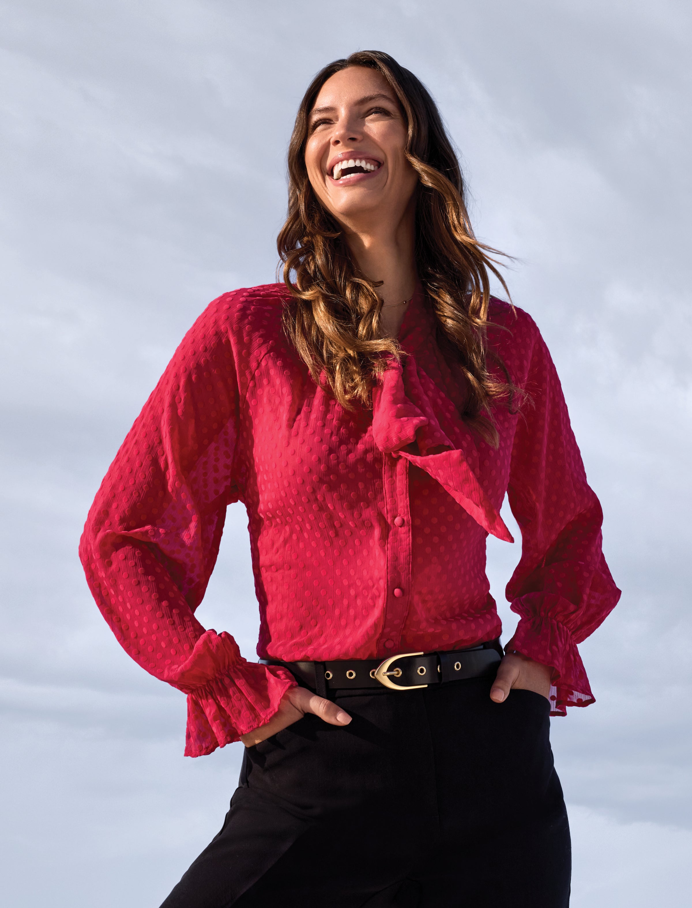 Woman wearing a pink blouse with a blurred background
